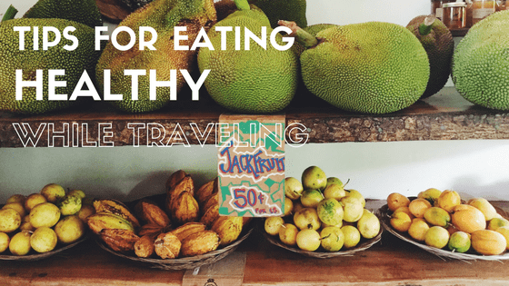 A view of a produce stand with a price tag reading Jackfruit Fifty cents each, captioned 10 tips for healthy eating while traveling By ourfamilypassport.com