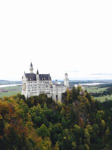 neuschwanstein castle in the fall foliage to show best things to do in Munich