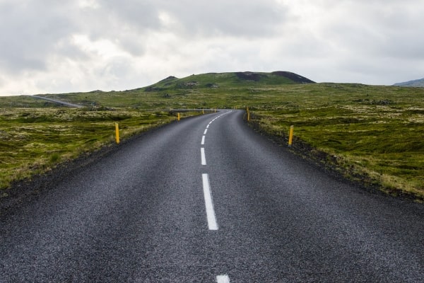 open two lane road for road trip tips