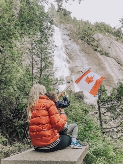 mom and child playing at shannon falls in whistler canada