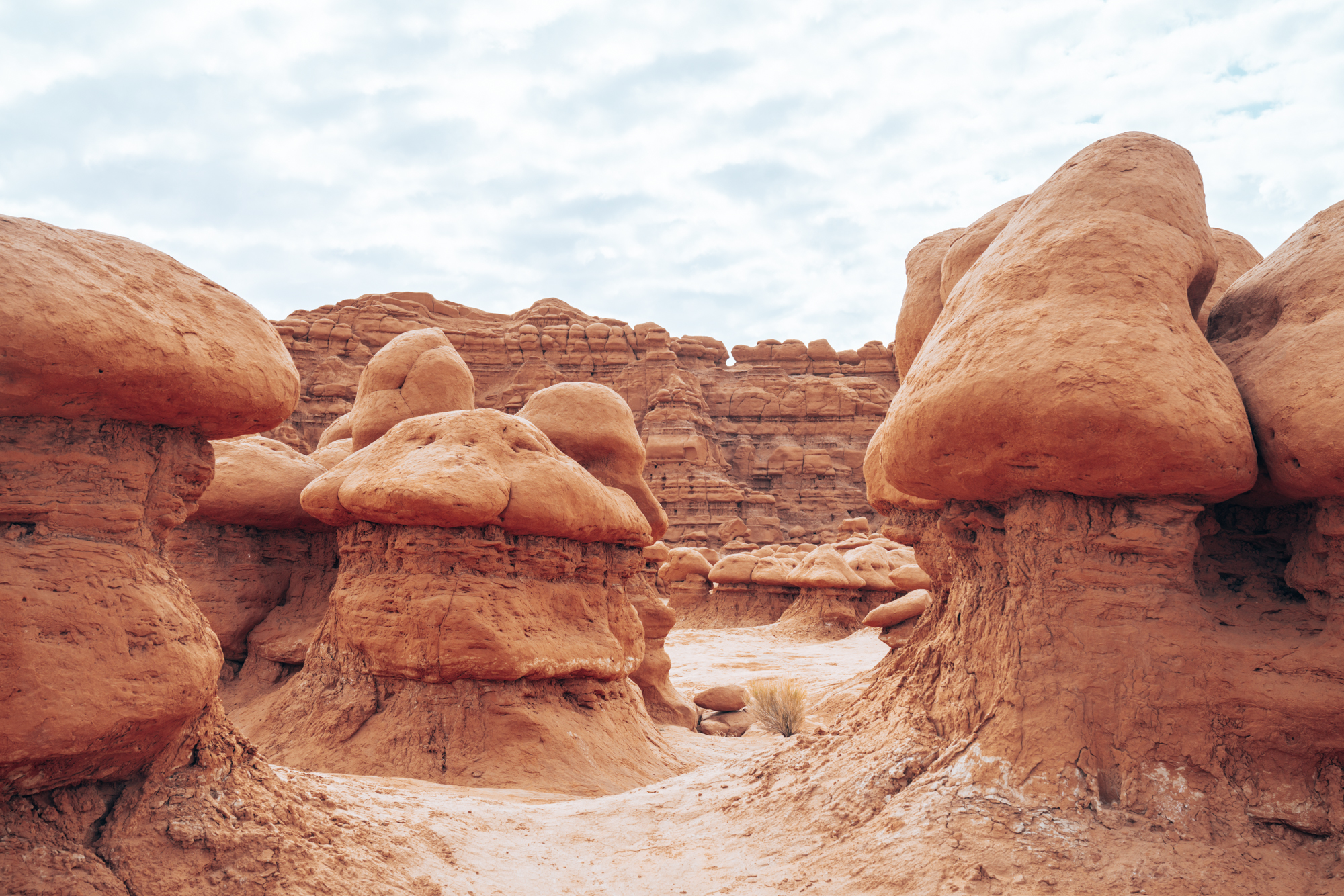 A close up look of red hoodoo rocks against a blue sky. 