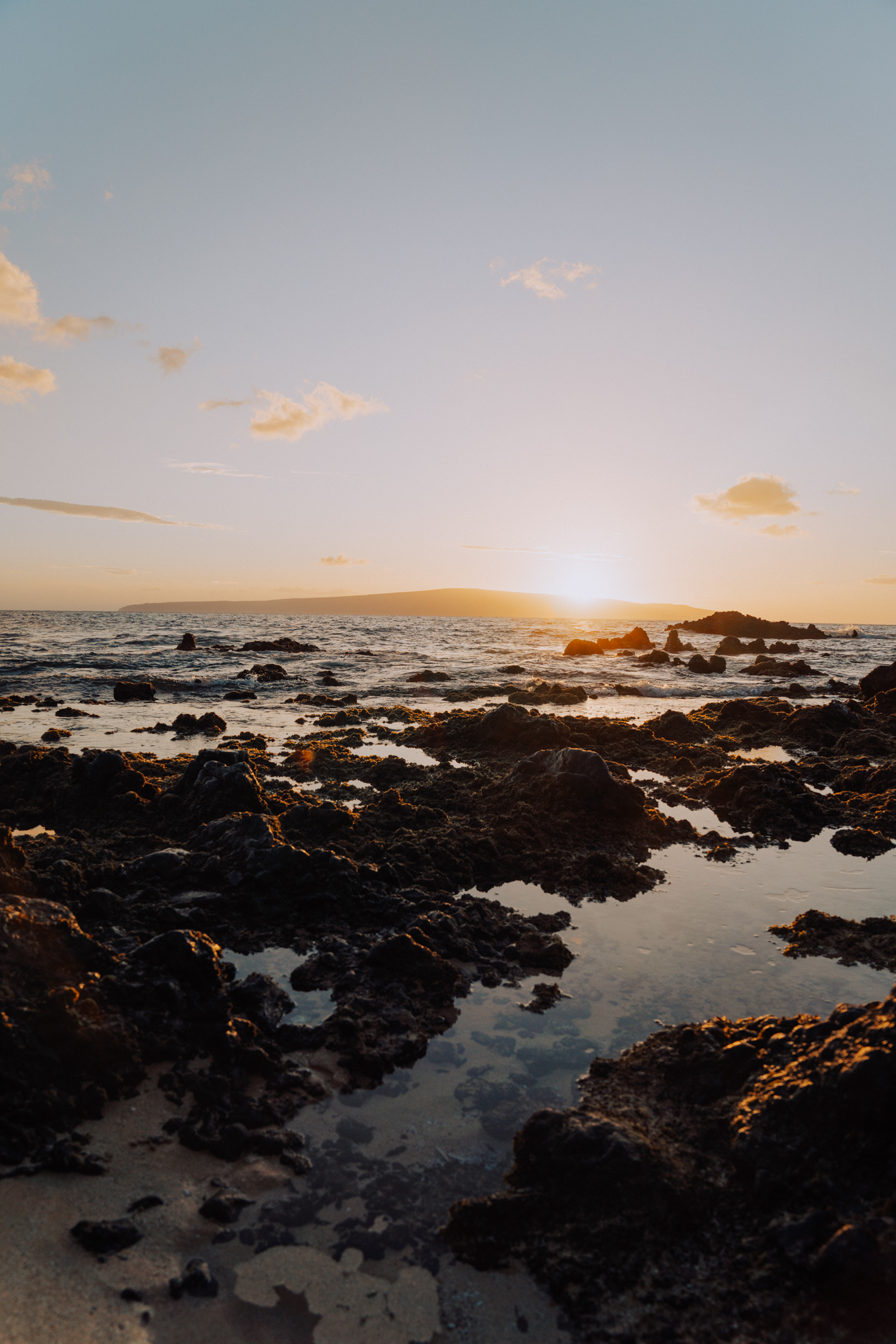 sunset over a rocky beach in Hawaii