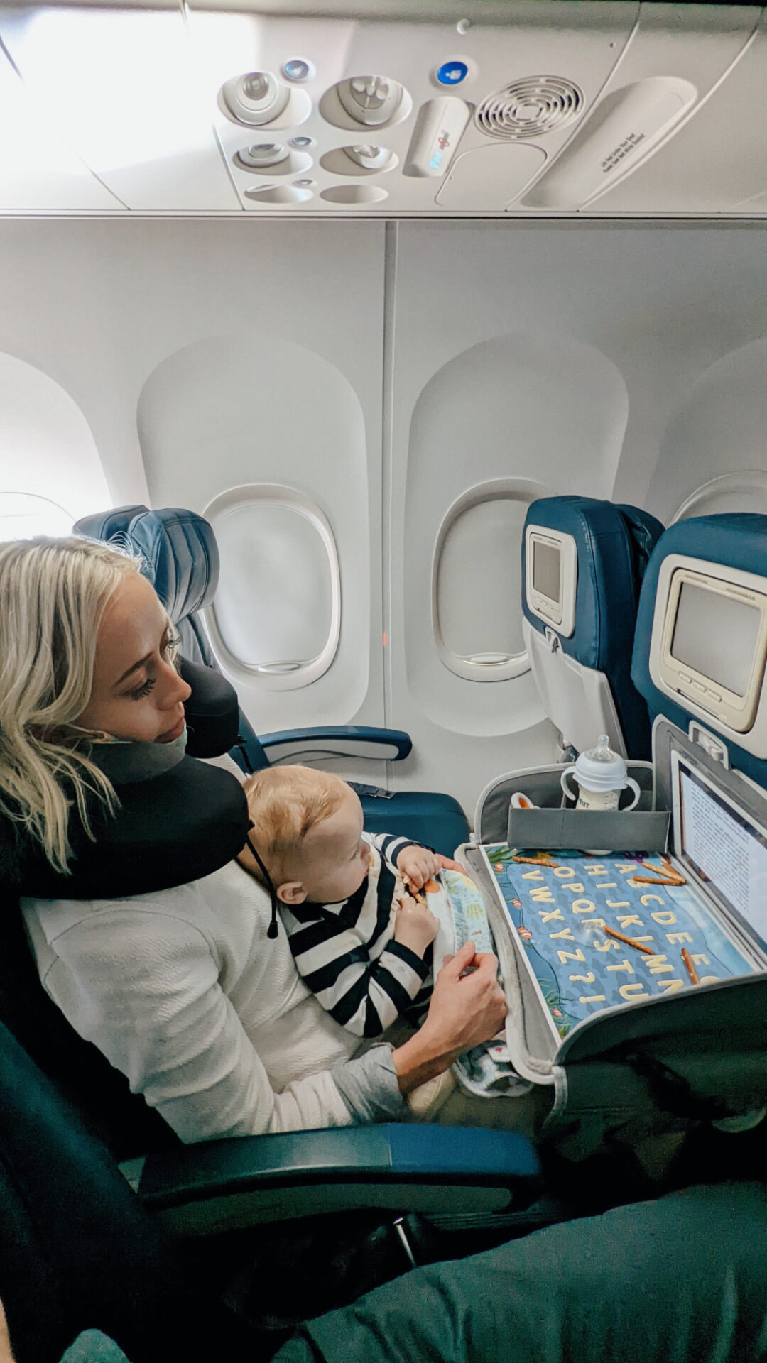 Kam and son doing activity on airplane during flight