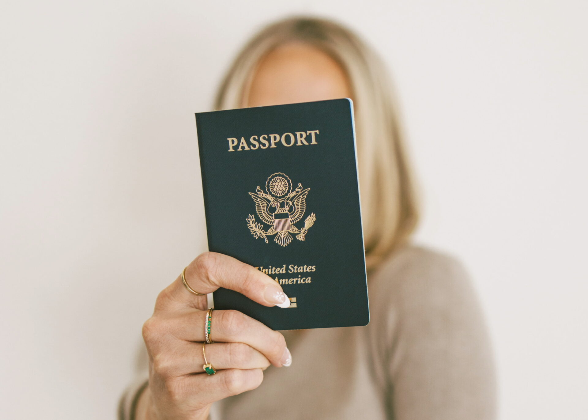 Kam holding United States passport for international travel