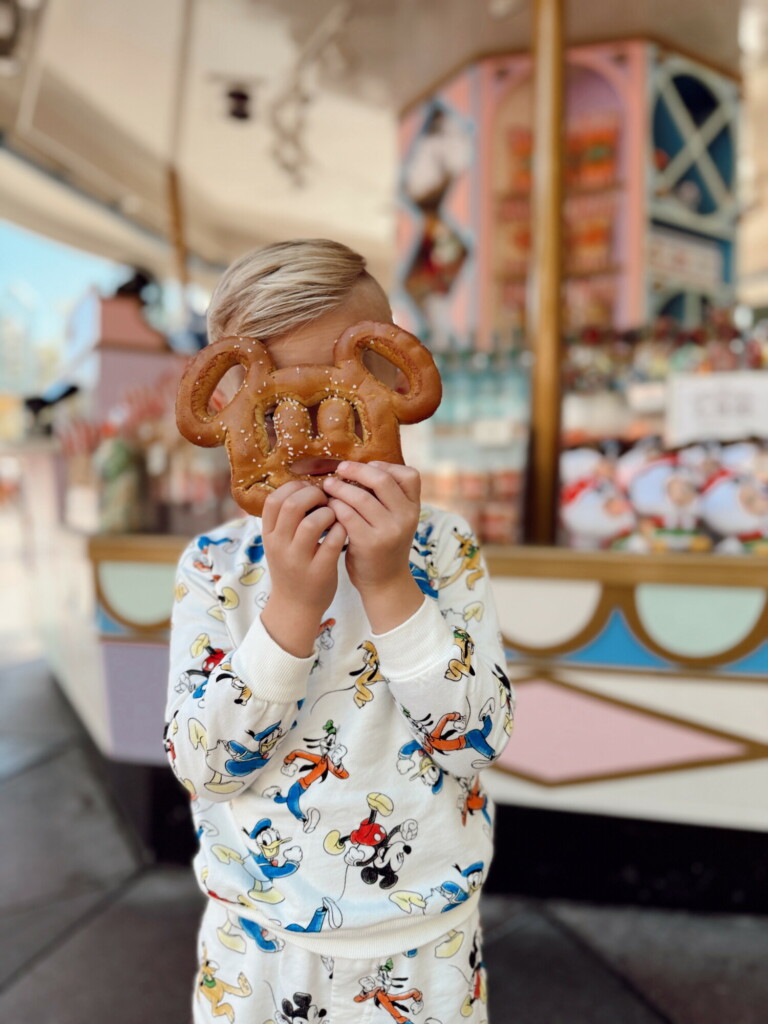 Child with Mickey Mouse pretzel at Disneyland carousel