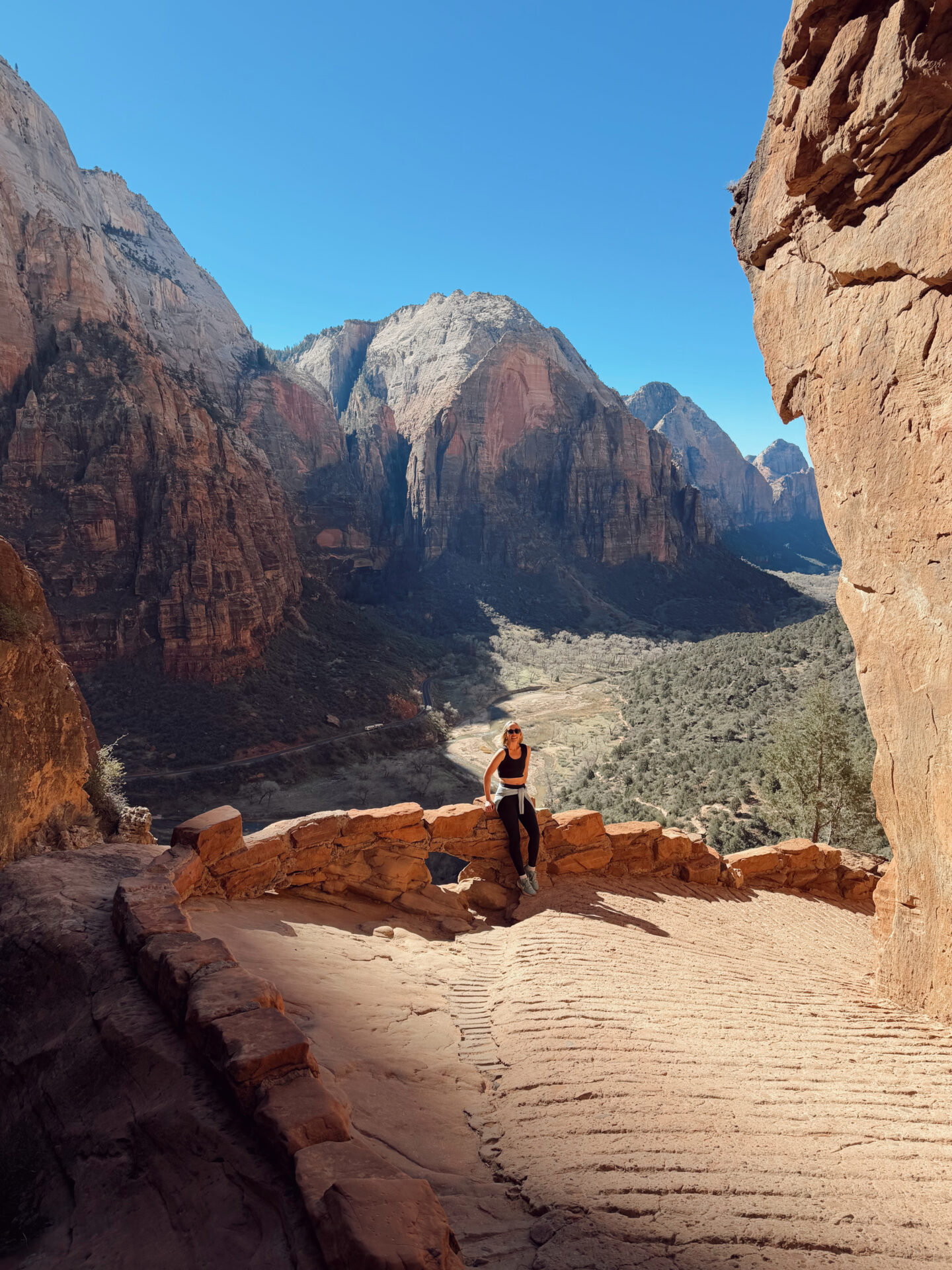 Woman at Scout Lookout on the West Rim Trail overlooking Angels Landing and the main Zion Canyon