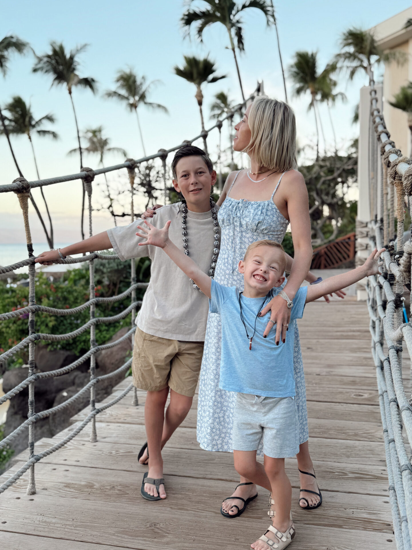 Mom and two kids posing on the rope bridge at the Hyatt Regency Maui resort