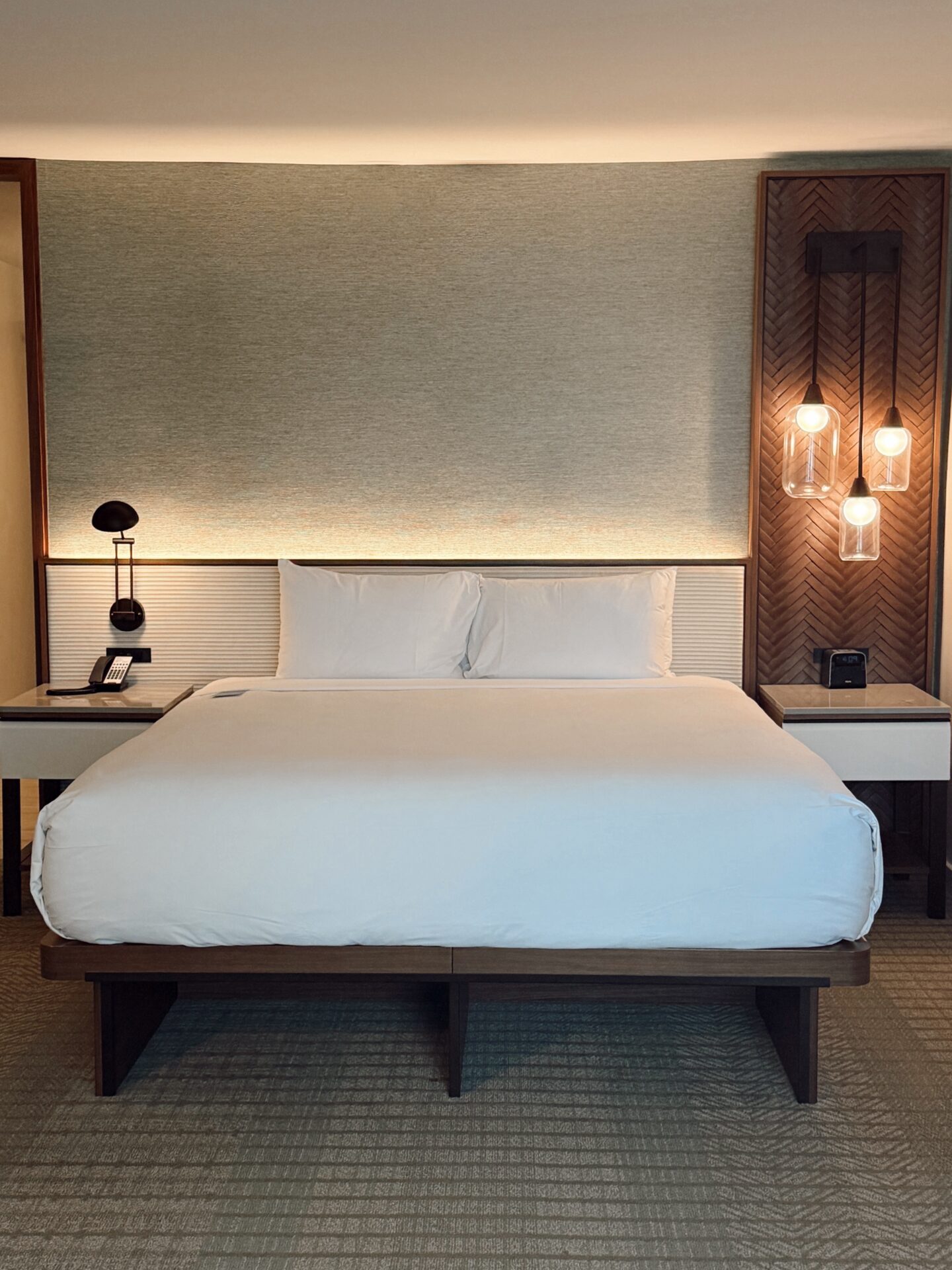 Renovated king bed room at the Hyatt Regency Maui with modern lighting and wood accents