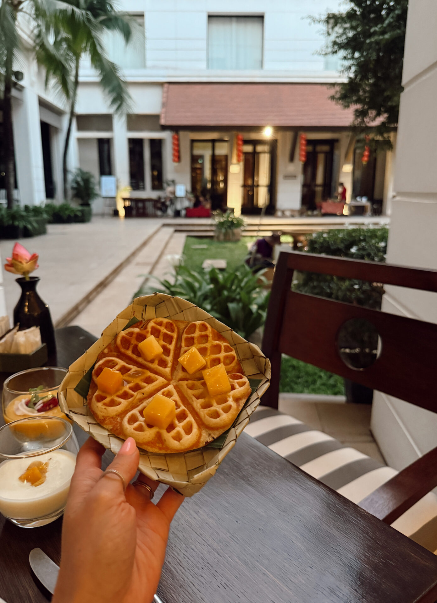 Heart-shaped Khmer waffles topped with mango served in a woven basket at Park Hyatt Siem Reap breakfast