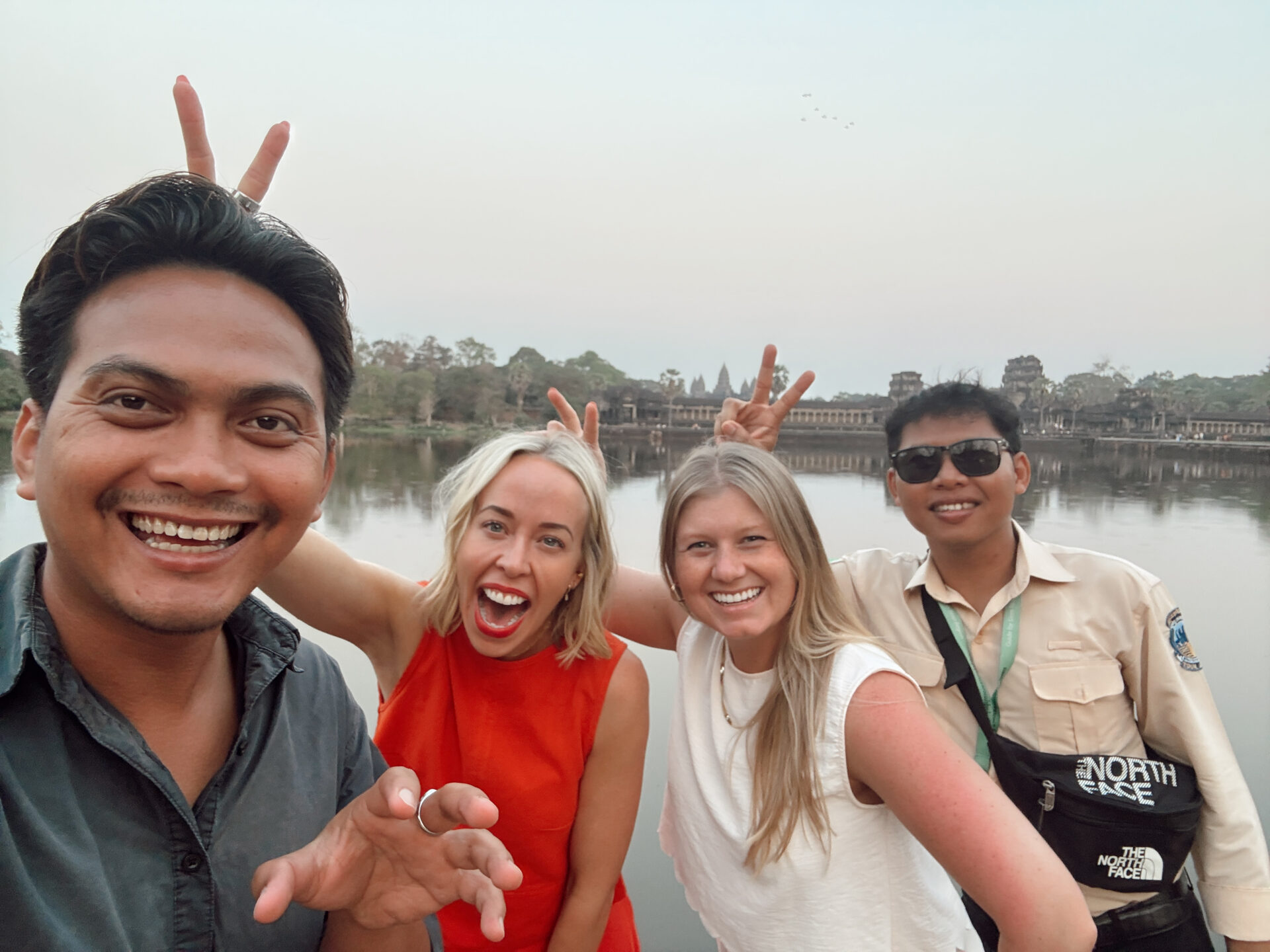 Group selfie Thanut Tours and guides at the Angkor Wat moat in Siem Reap