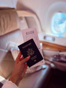 US passport and Singapore Airlines business boarding pass on board the plane