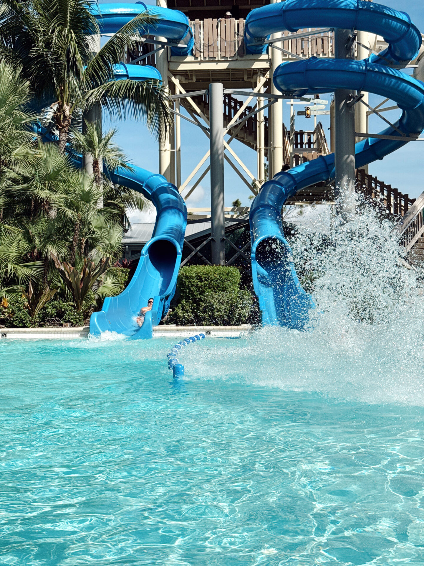 Tall blue water slides splashing into the pool at Hyatt Regency Coconut Point Resort and Spa