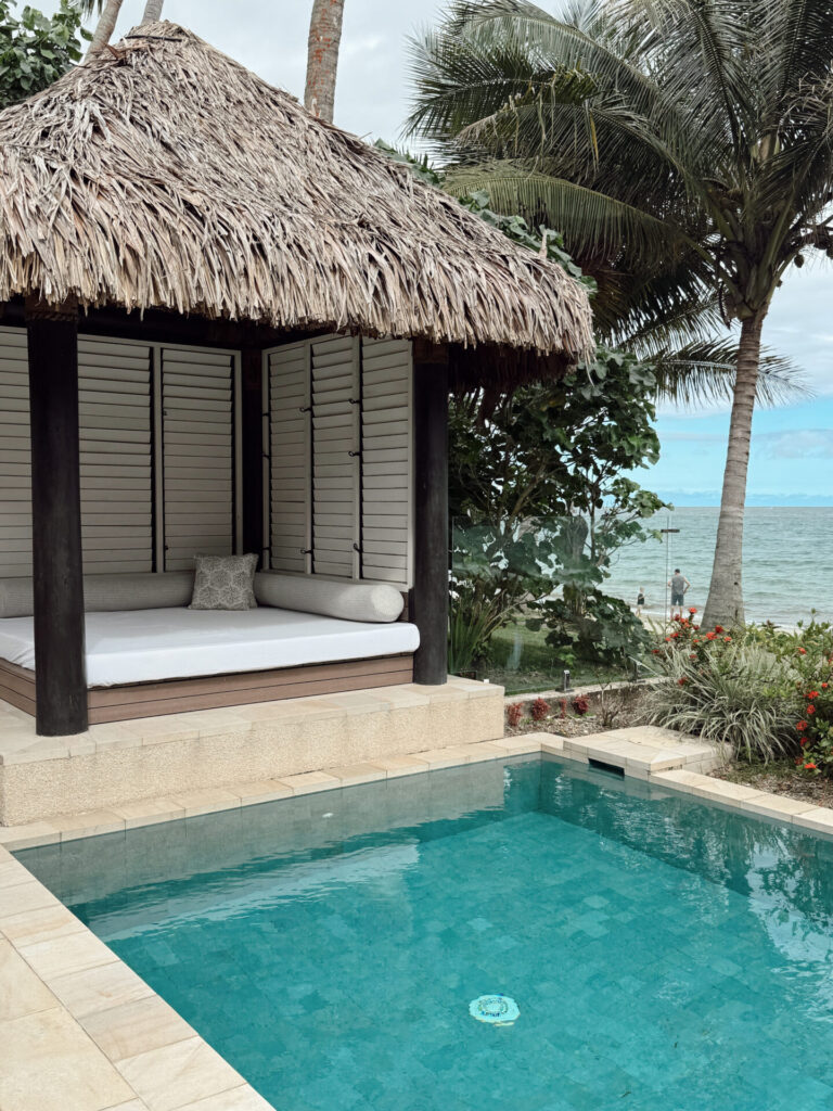 Private plunge pool and thatched daybed cabana at a Fiji beachfront villa overlooking the ocean at Nanuku