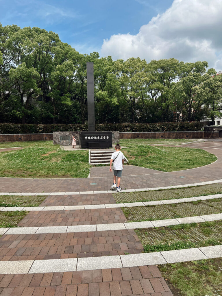 Boy walking toward the Hypocenter Monument marking ground zero of the atomic bombing in Nagasaki