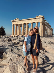 Mom and son standing together in front of the Parthenon on the Acropolis in Athens