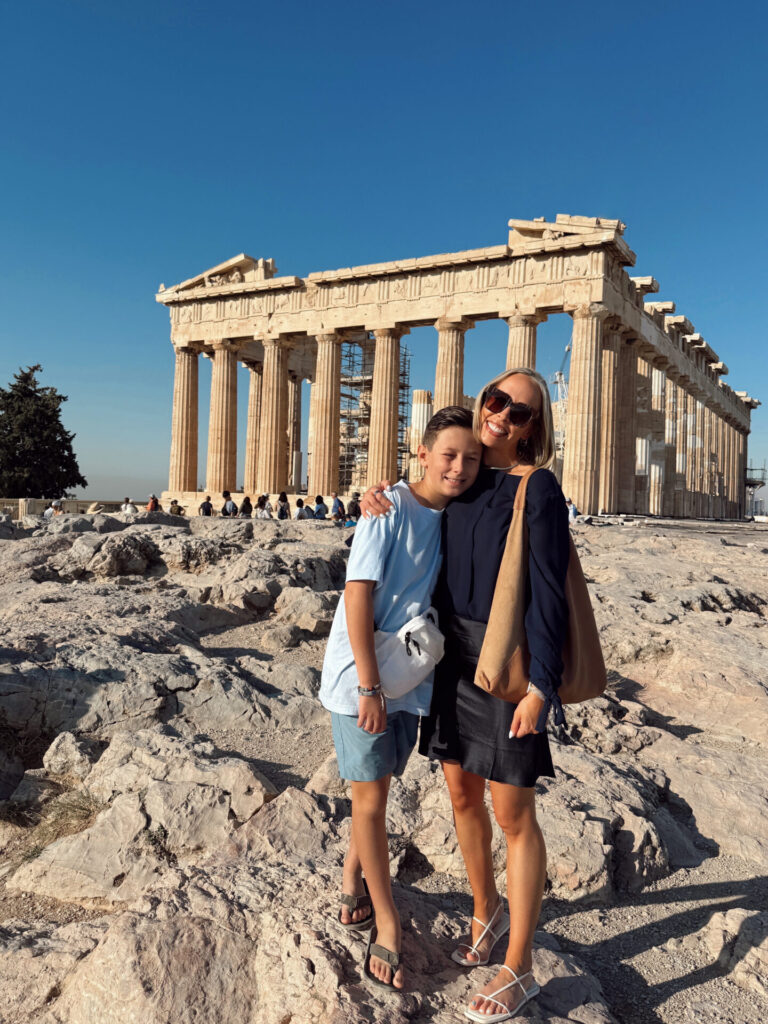 Mom and son standing together in front of the Parthenon on the Acropolis in Athens