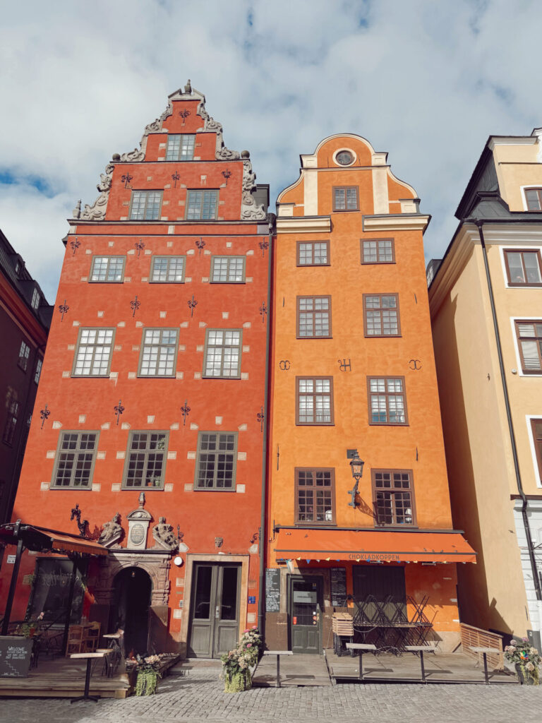 Colorful red and orange buildings in Stortorget square, Gamla Stan, Stockholm, on a family trip booked with Capital One miles